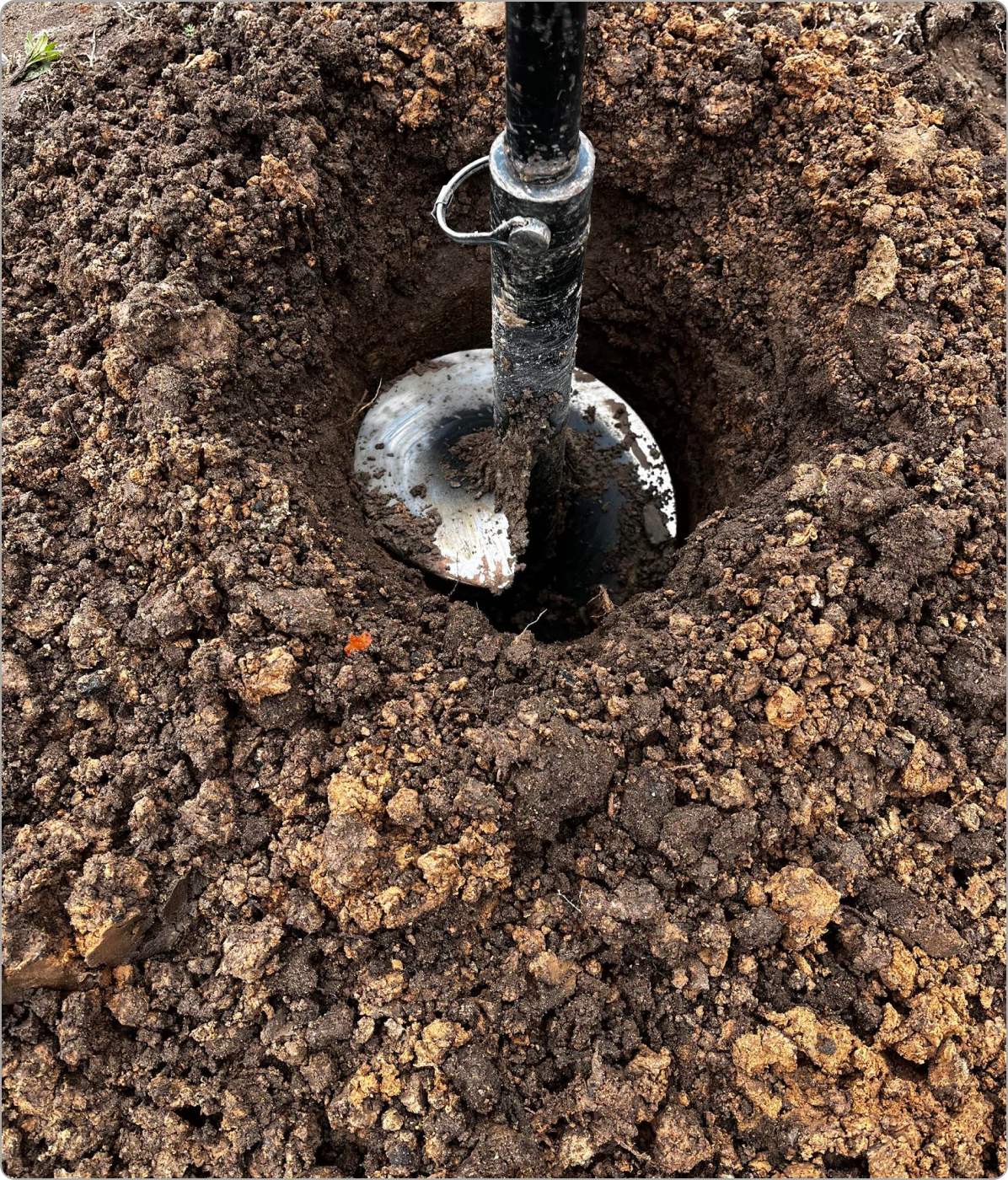 Solid flight auger drilling a borehole