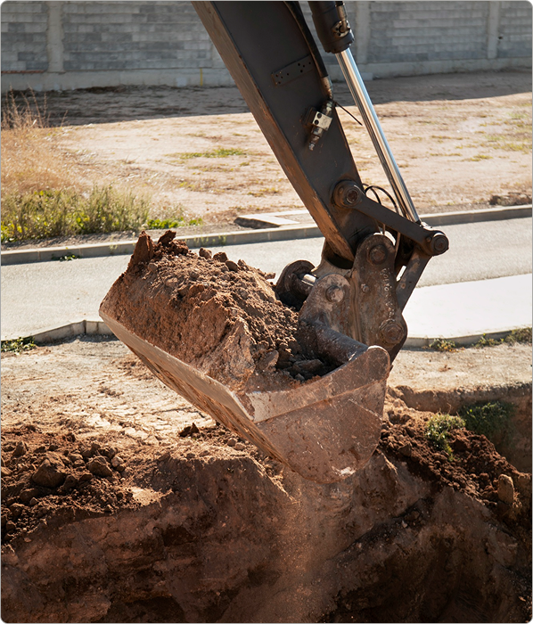Solid flight auger drilling a borehole on a commercial site